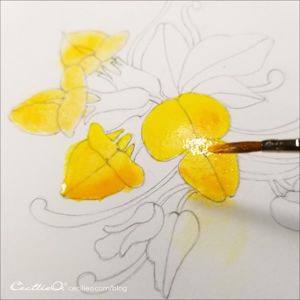 Painting yellow watercolor on the flower petals.