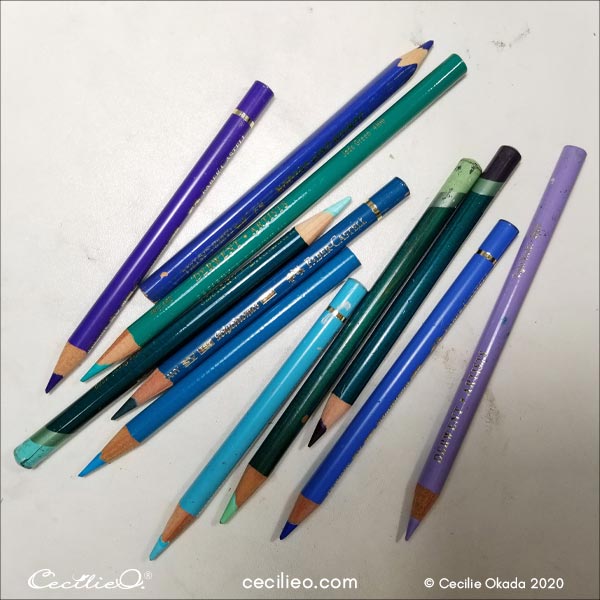 Range of colored pencils in turquoice, from dark to light colors.