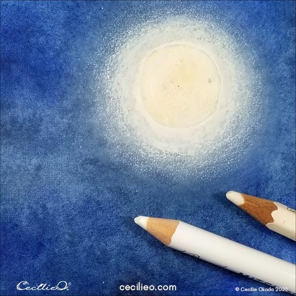 Drawing white light around the moon with white colored pencils.