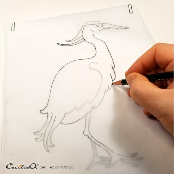 Trace the drawing with a soft pencil.