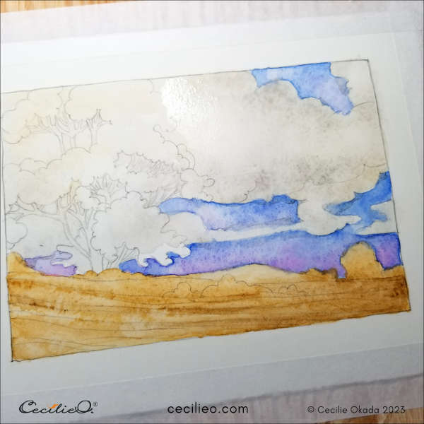 Adding a bit of grey to the clouds and covering the tree in the same go.