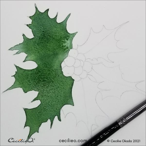 Painting the leaves with blue-green watercolor.