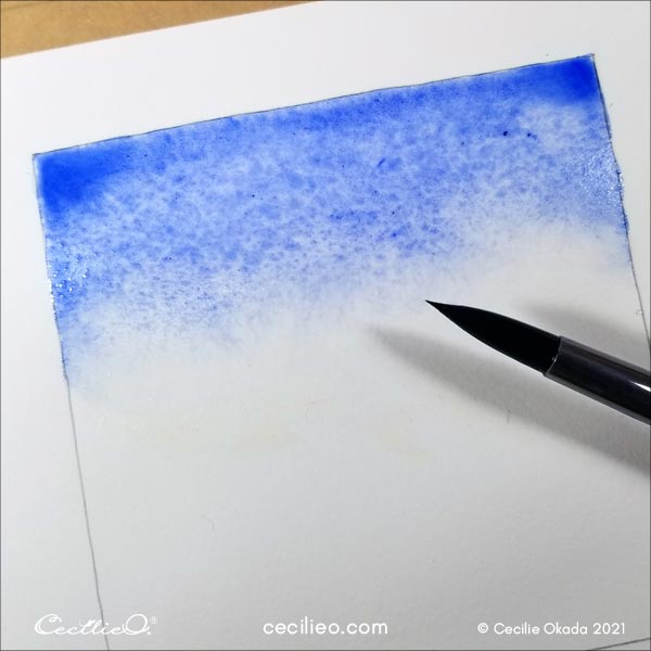 Painting the blue watercolor sky.