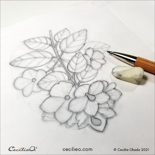 Outlining the flower using tracing paper over the sketch.